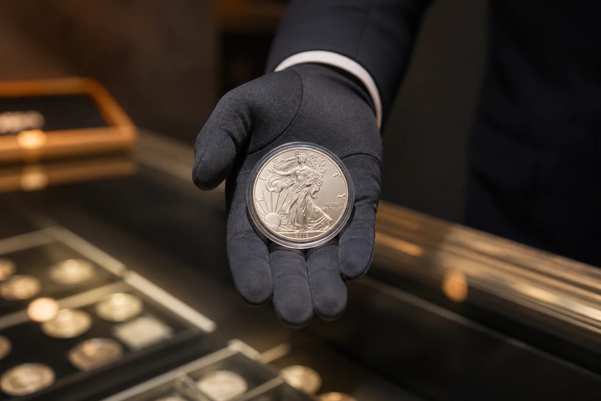 A dealer presenting a silver eagle across the counter