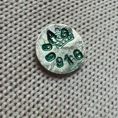 1 Gram of .999 stamped round with green lettering