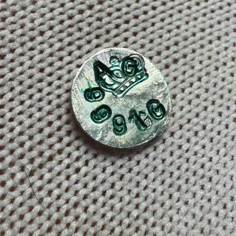1 Gram of .999 stamped round with green lettering